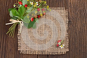 Wild strawberries on rustic background