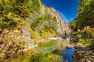 Wild stream through mountainous landscape with rocky gorge on a