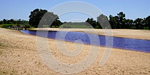 Wild water beach sand coast in Ares on arcachon bay in France