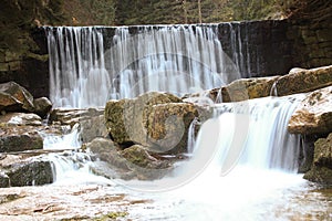 Wild waterfall in the Polish mountains. River with cascades