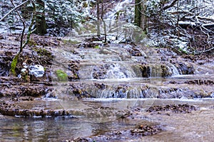 Wild beautiful waterfall in the winter, Romania photo