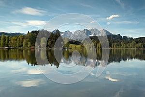Wilder Kaiser mountain range reflected in a mountain lake photo