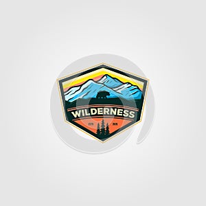 Wilderness mountain adventure badge vintage logo vector illustration