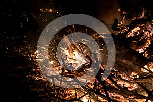 Wildfire burning on grass and wood at night. dangerous place on fire. close-up fire shot.