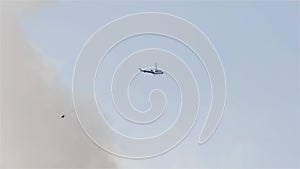 Wildfire Service Helicopter flying over BC Forest Fire and Smoke on the mountain near Hope