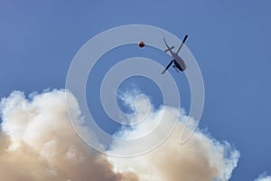 Wildfire Service Helicopter flying over BC Forest Fire and Smoke on the mountain near Hope