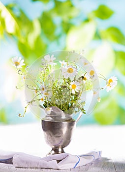 Wildflowers in an old metal creamer . Summer concept
