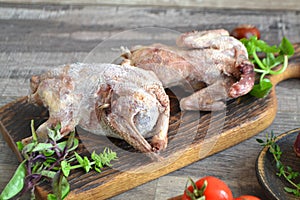 Wildfowl hunting. Two raw woodcock on rustic table, russian cuisine