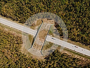 Wildlife crossing-a bridge over a highway in the forest. The view from the top photo