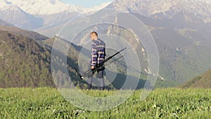 Wildlife nature photographer walking with tripod at mountain landscape