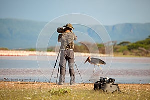 Wildlife photographer in action by a lake