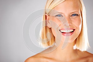 She will bring all the attention here - Copyspace. Portrait of a pretty young woman with a large grin and copyspace