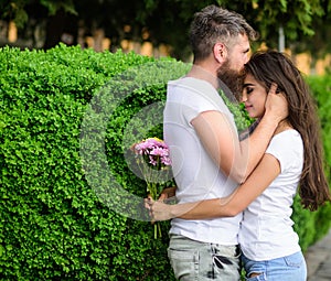 He will never let her go. Couple in love hugs on date in park green bushes background. Man fall in love with gorgeous