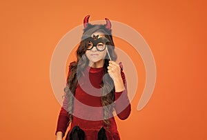 will terrify you. child celebrate autumn holiday. teenage girl in devil horns celebrate halloween. happy halloween photo