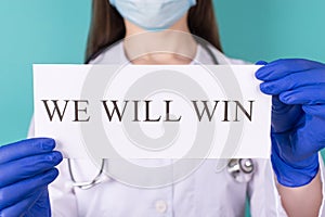 We will win concept. Close-up cropped photo of practitioner therapist physician doctor in white coat gloves mask holding we will