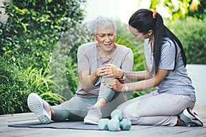 Will you carry me home. an older woman holding an injured knee during a session with a physiotherapist.