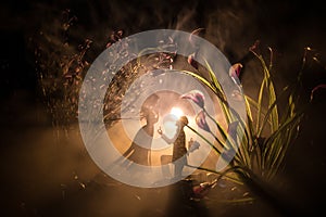 Will you marry me? Silhouette of young man staying on the knee and making proposal for his lovely girl on the beach against dark t