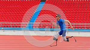 Willful Asian athlete speeds up on stadium track, aiming to break his record with prosthetic blades photo