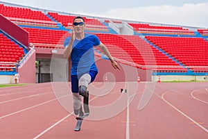 Willful Asian male athlete with prosthetics takes off speedily to surpass his running record on stadium track, motion blur depicts photo