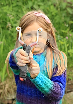 Willful girl with a slingshot photo
