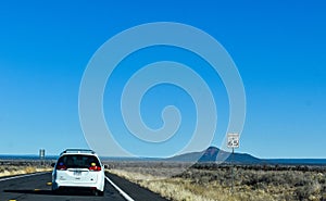 Desert scenery along the highway from Williams, Arizona to the Grand Canyon with bushes and brush in the foreground