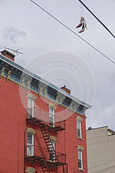 Williamsburg, Brooklyn: A pair of high-heeled shoes hanging by strings photo