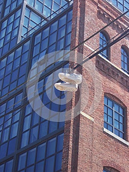 Williamsburg, Brooklyn, USA: A pair of sneakers hanging by strings over a power line photo