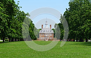 Williamsburg, Virginia - June 30, 2020 - The Governor`s Palace surrounded by green trees