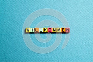 Willkommen - word concept on cubes