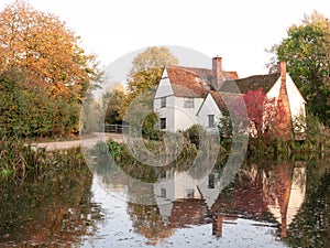 willy lotts cottage at flatford mill in suffolk in autumn reflections in lake photo