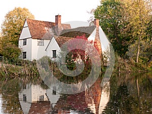 willy lotts cottage at flatford mill in suffolk in autumn reflections in lake