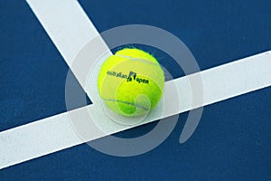 Wilson tennis ball with Australian Open logo on tennis court