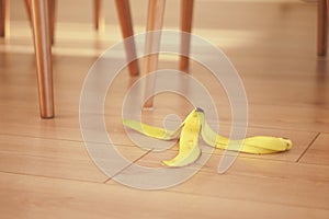 A Wilted Banana on a Wooden Floor Surrounded by White Fabric, Emphasizing the Contrast photo