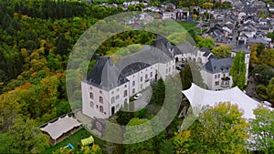 Wiltz, Luxembourg. Aerial shot at autumn of Wiltz Castle. Cloudy weather drone footage