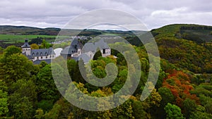 Wiltz, Luxembourg. Aerial shot at autumn of Wiltz Castle. Cloudy weather drone footage