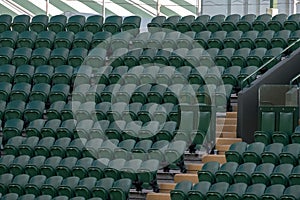 Rows of empty green spectators` chairs at Wimbledon All England Lawn Tennis Club.