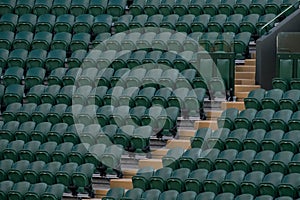 Rows of empty green spectators` chairs at Wimbledon All England Lawn Tennis Club.