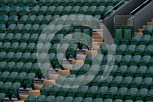 Rows of empty green spectators` chairs at Wimbledon All England Lawn Tennis Club.