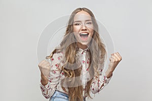 Win! Emotional blonde woman shout and have a happiness look and