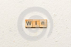 WIN word written on wood block. WIN text on cement table for your desing, concept