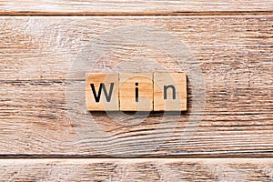 WIN word written on wood block. WIN text on wooden table for your desing, concept