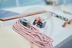 Winch and nautical ropes on a sailing boat in the port