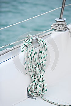 Winch and nautical ropes on a sailing boat in the port