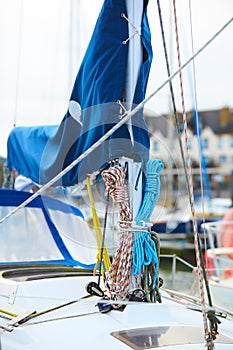 Winch and nautical ropes on a sailing boat in the port