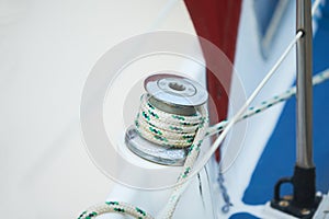 Winch and nautical ropes on a sailing boat in the port