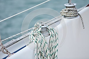 Winch and nautical ropes on a sailing boat in the port