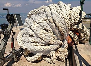 A winch of a sailing boat with a rope wound up.