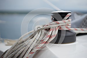 Winch windlass with halyard and sheet rope on sail boat photo