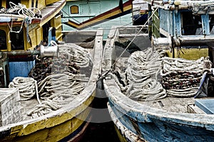 Winches and coiled ropes on woden fishing boats