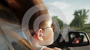 Wind Blowing Through Girl's Hair In a car. Sunset